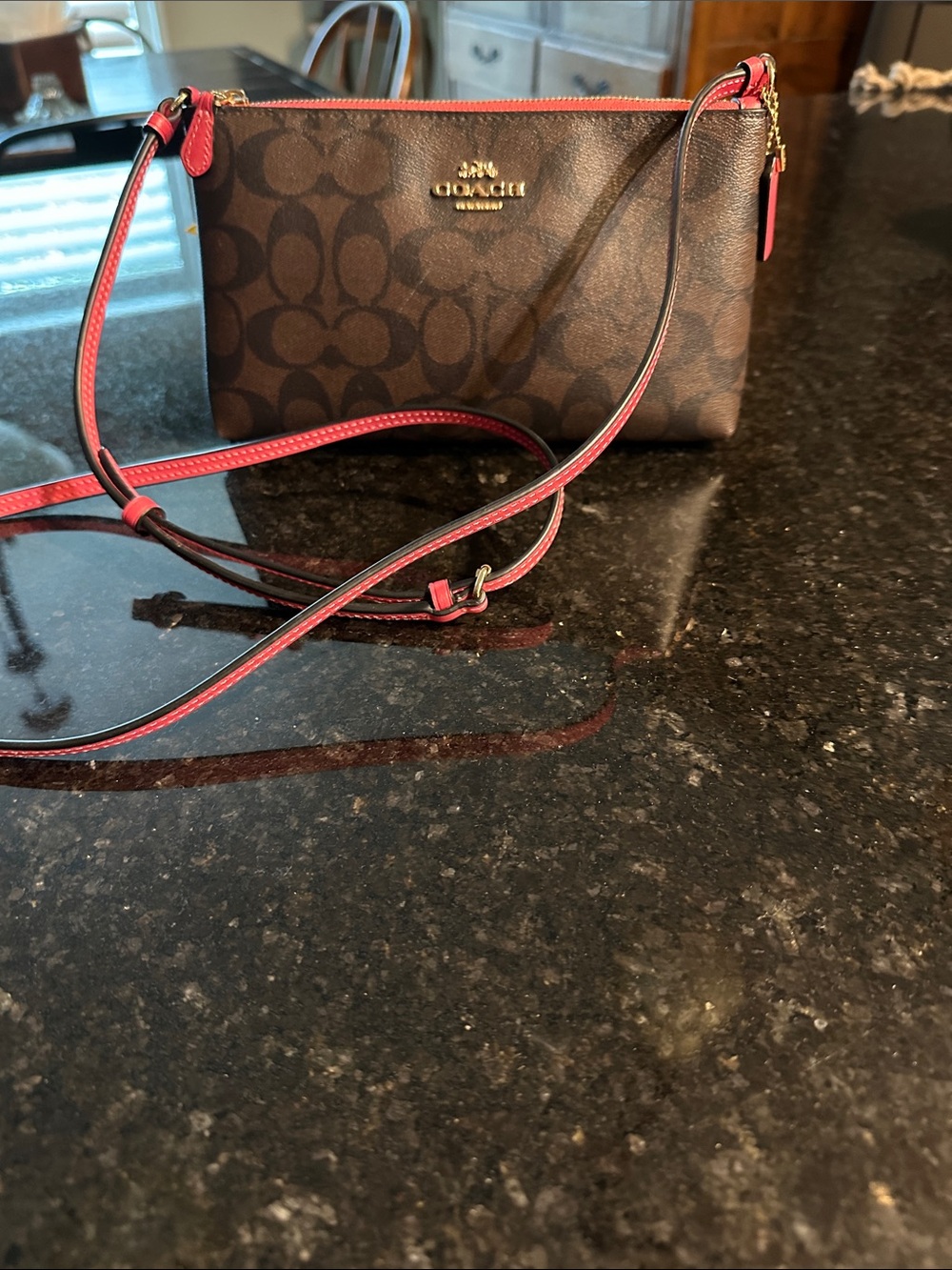 Brown Coach signature crossbody purse
